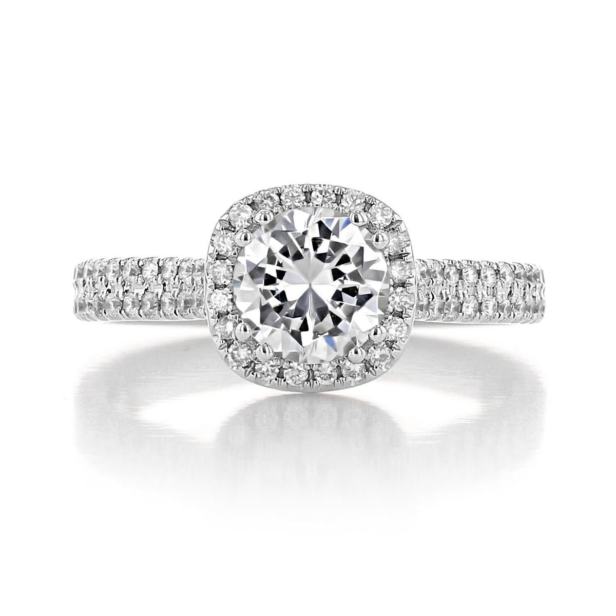 Zuma | Round Halo Engagement Ring featuring a round center stone, cushion halo setting, and a band of pavé-set diamonds.