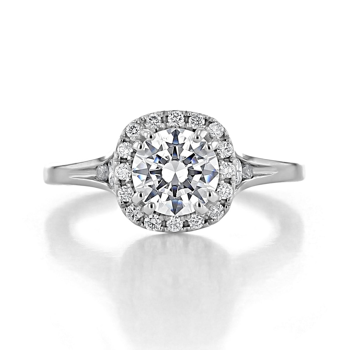 A Renee round halo engagement ring by EverTrue featuring a round-cut diamond, a halo of spotlight diamonds, and a metal band.