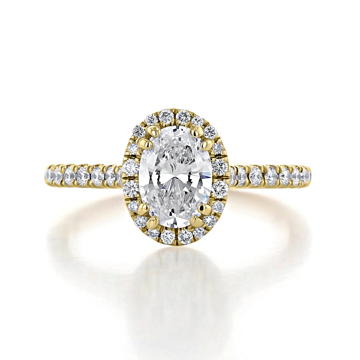 Isla | Oval Halo Engagement Ring in gold, featuring an oval-cut center diamond in a halo setting with a pavé-set band of VS1/VS2 clarity round diamonds.