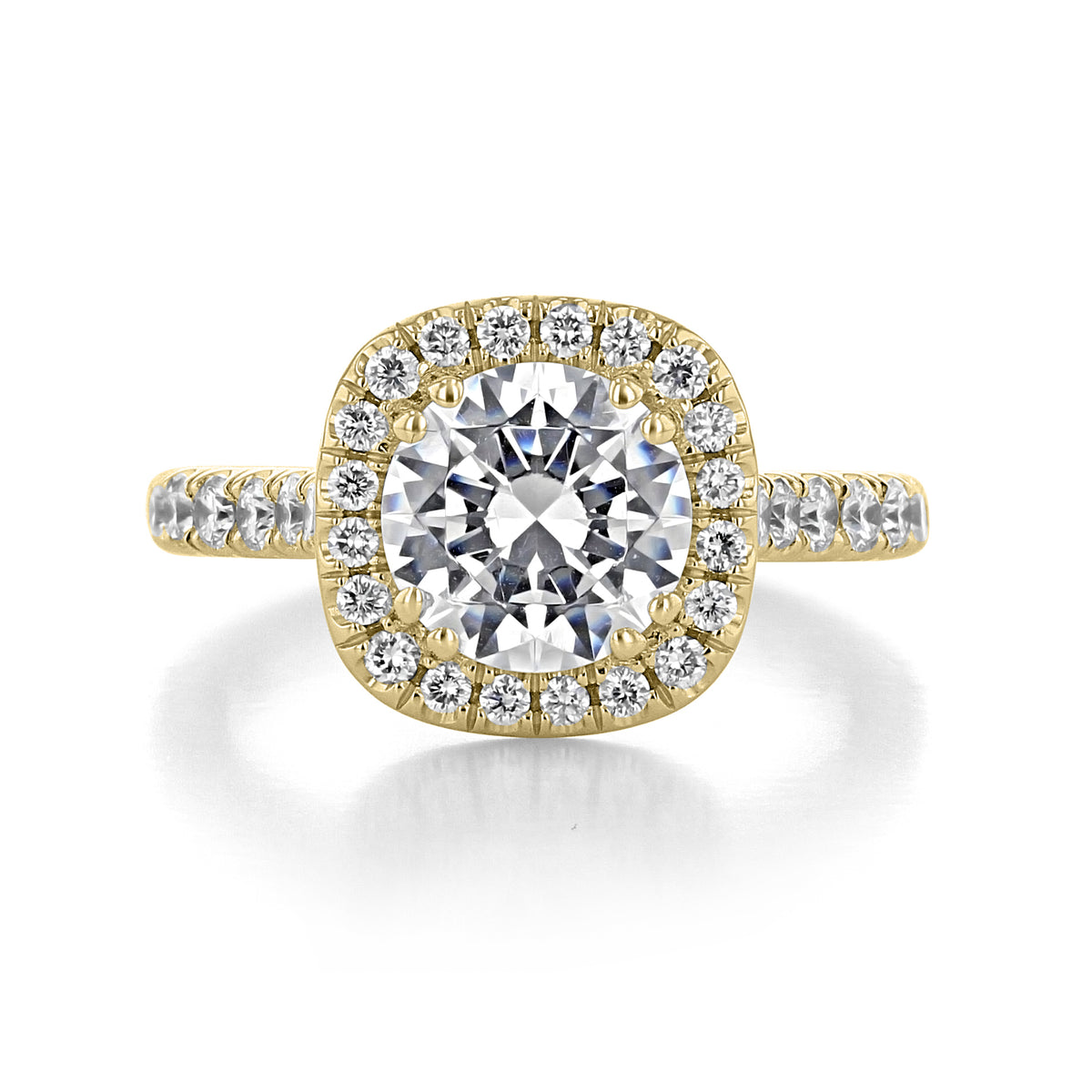 Clarita | Round Halo Engagement Ring in gold featuring a round center stone surrounded by a cushion-shaped diamond halo, with micro-prong diamonds set along the band.