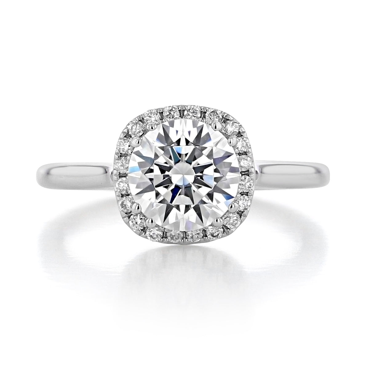 The Isla | Round Halo Solitaire Engagement Ring by evertrue by Icing On The Ring features a round-cut diamond solitaire with a square-shaped halo of smaller accent diamonds on a polished 14k white gold band.