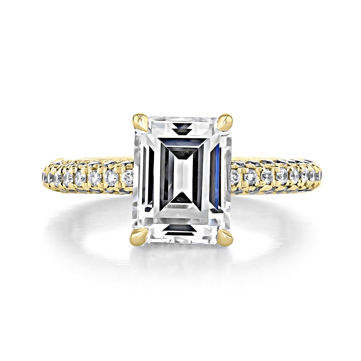 Elena | Emerald Triple Pavé Engagement Ring featuring an emerald-cut stone on a yellow gold band with rows of pavé diamonds and a hidden halo.