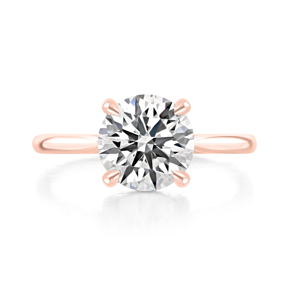 Doheny | Round Cathedral Solitaire Engagement Ring in 14k rose gold, top view of a round center diamond in a four-prong setting.