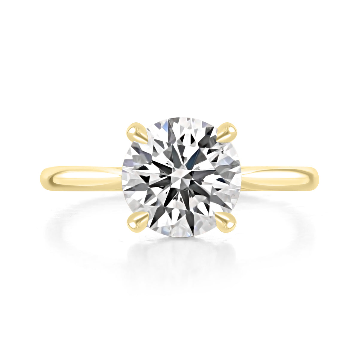 Doheny | Round Cathedral Solitaire Engagement Ring in 14k yellow gold, top view of a round center diamond in a four-prong setting.