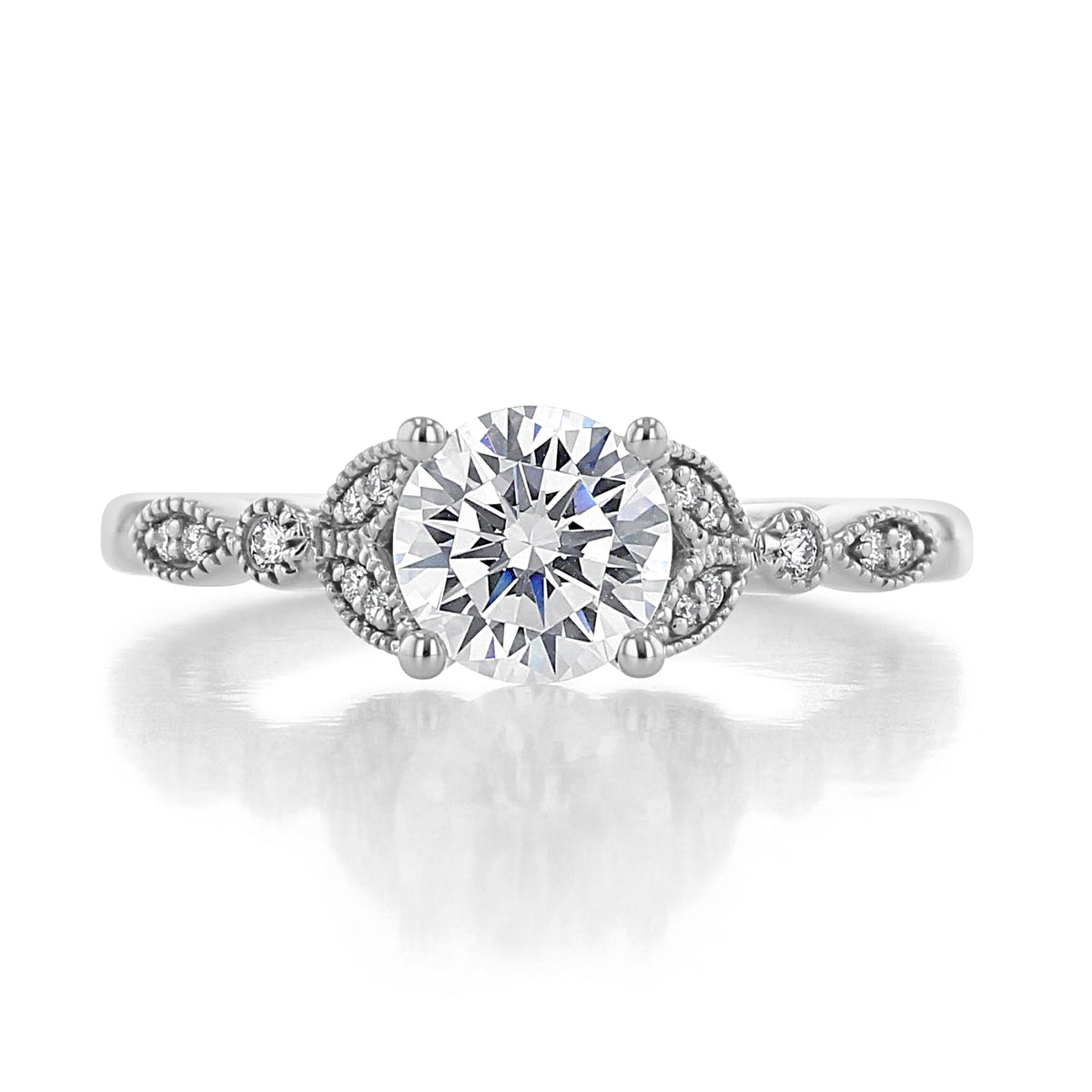 Gardenia round diamond engagement ring with a milgrain-detailed pavé band featuring floral-inspired accents.