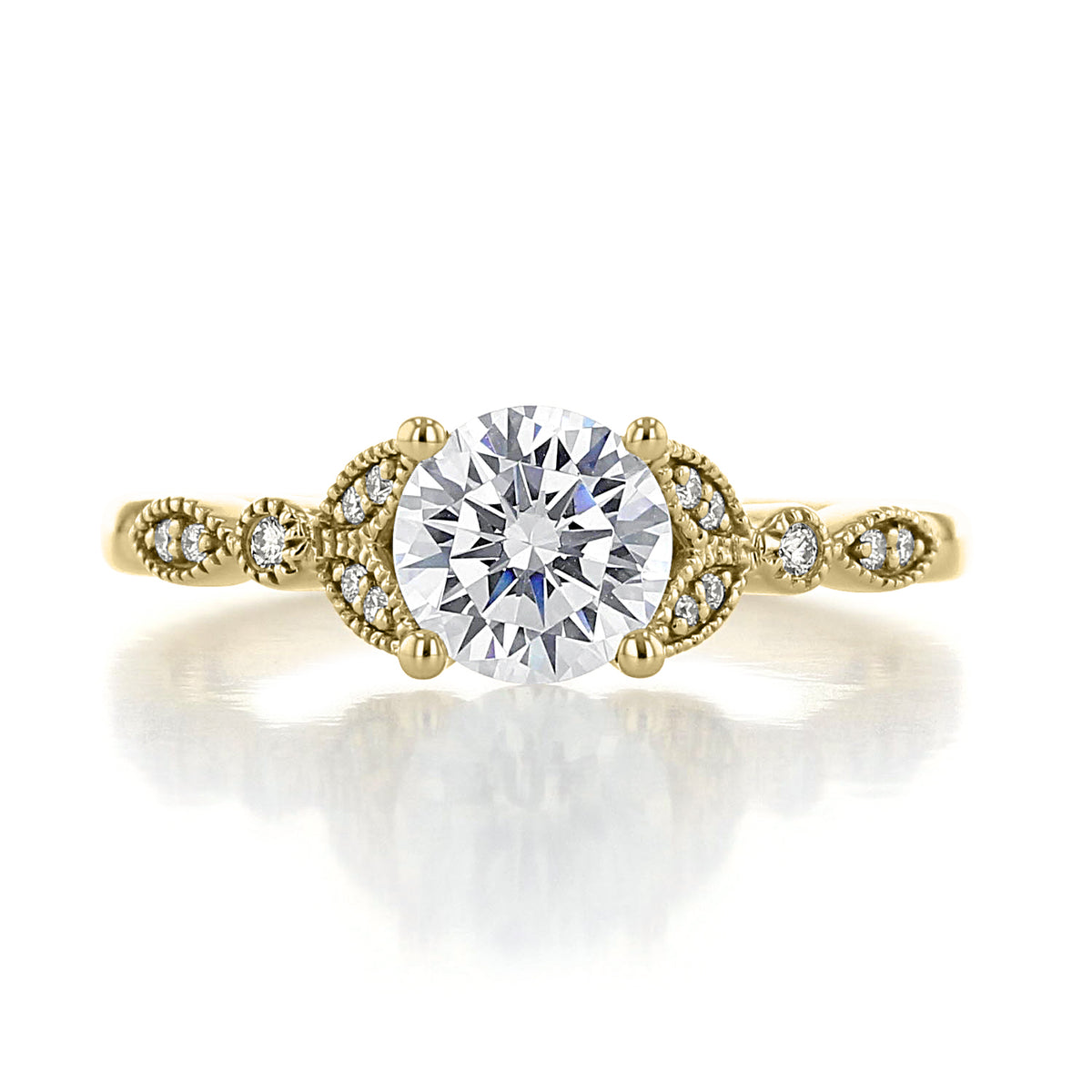 Gardenia | Round Floral Pavé Engagement Ring in gold, featuring a round diamond center stone flanked by pavé accent diamonds set in a decorative, vintage-inspired band with milgrain engravings.