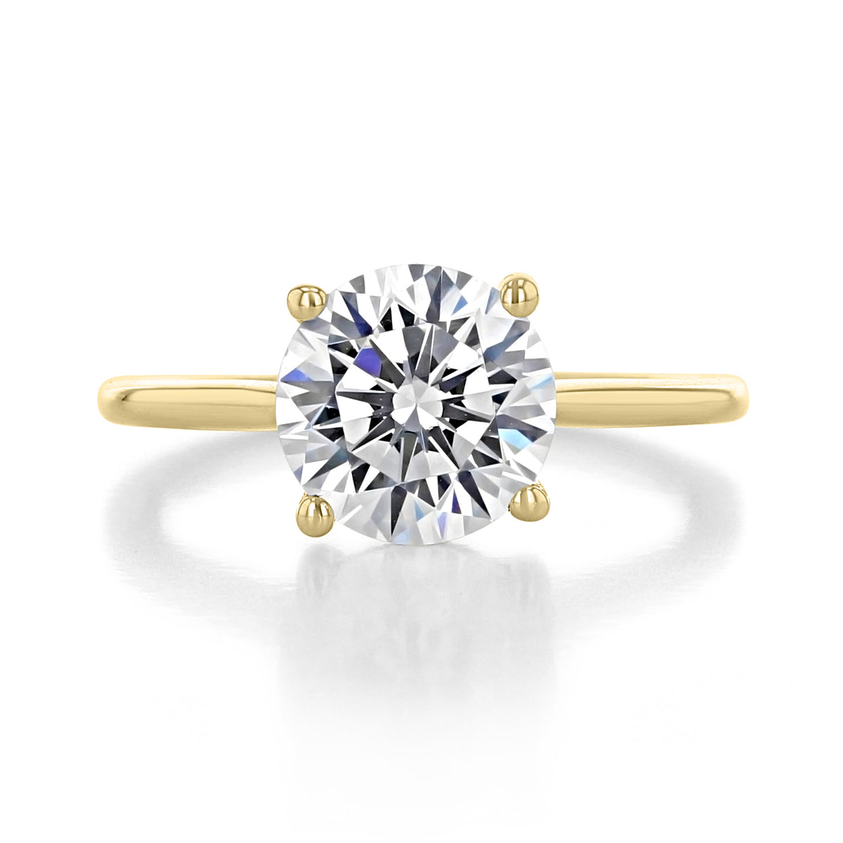 Waverly | Round Solitaire Engagement Ring featuring a round diamond, yellow gold band, and four-prong setting.