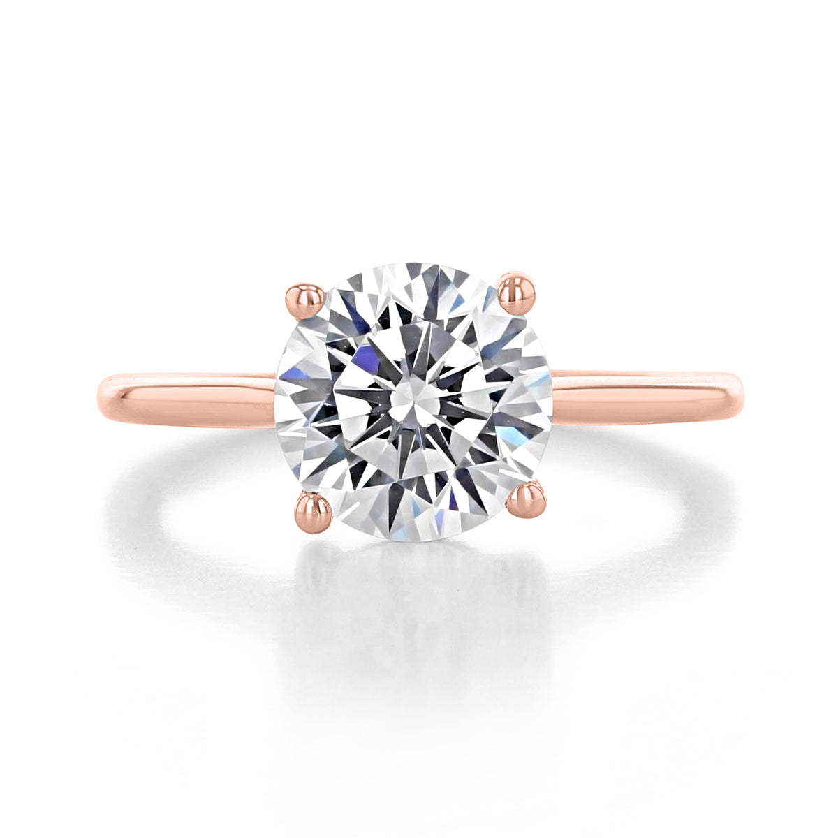 Waverly round solitaire engagement ring with a hidden halo on a thin rose gold band.