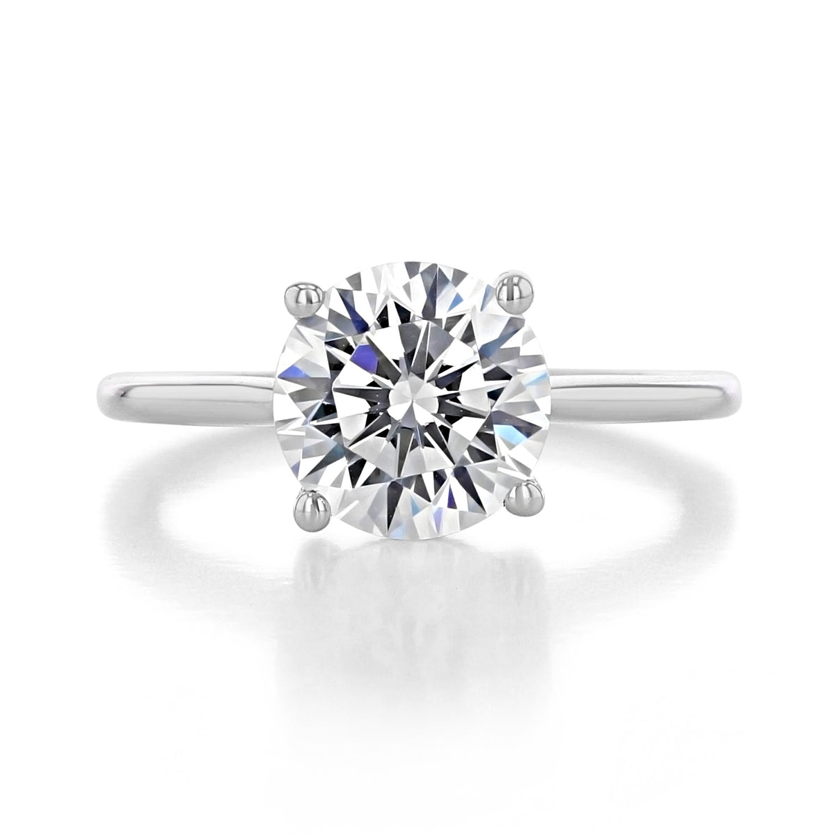 Waverly round solitaire engagement ring featuring a round brilliant-cut diamond on a thin metal band with four prongs.