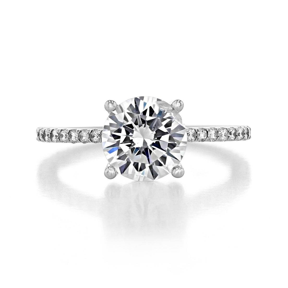 Lucerne | Round Micro-Prong Engagement Ring featuring a round brilliant-cut diamond in a four-prong setting with pavé-set diamonds along the band.