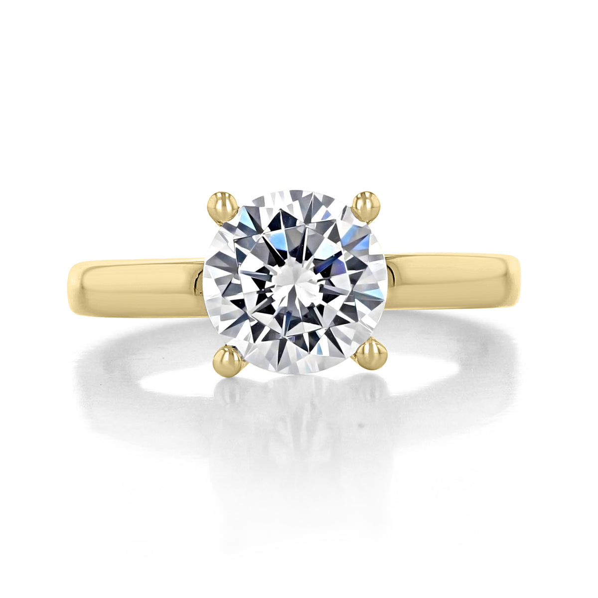 Cambria | Round Solitaire Engagement Ring by Gabriel & Co. featuring a round diamond on a gold band with a four-prong setting.
