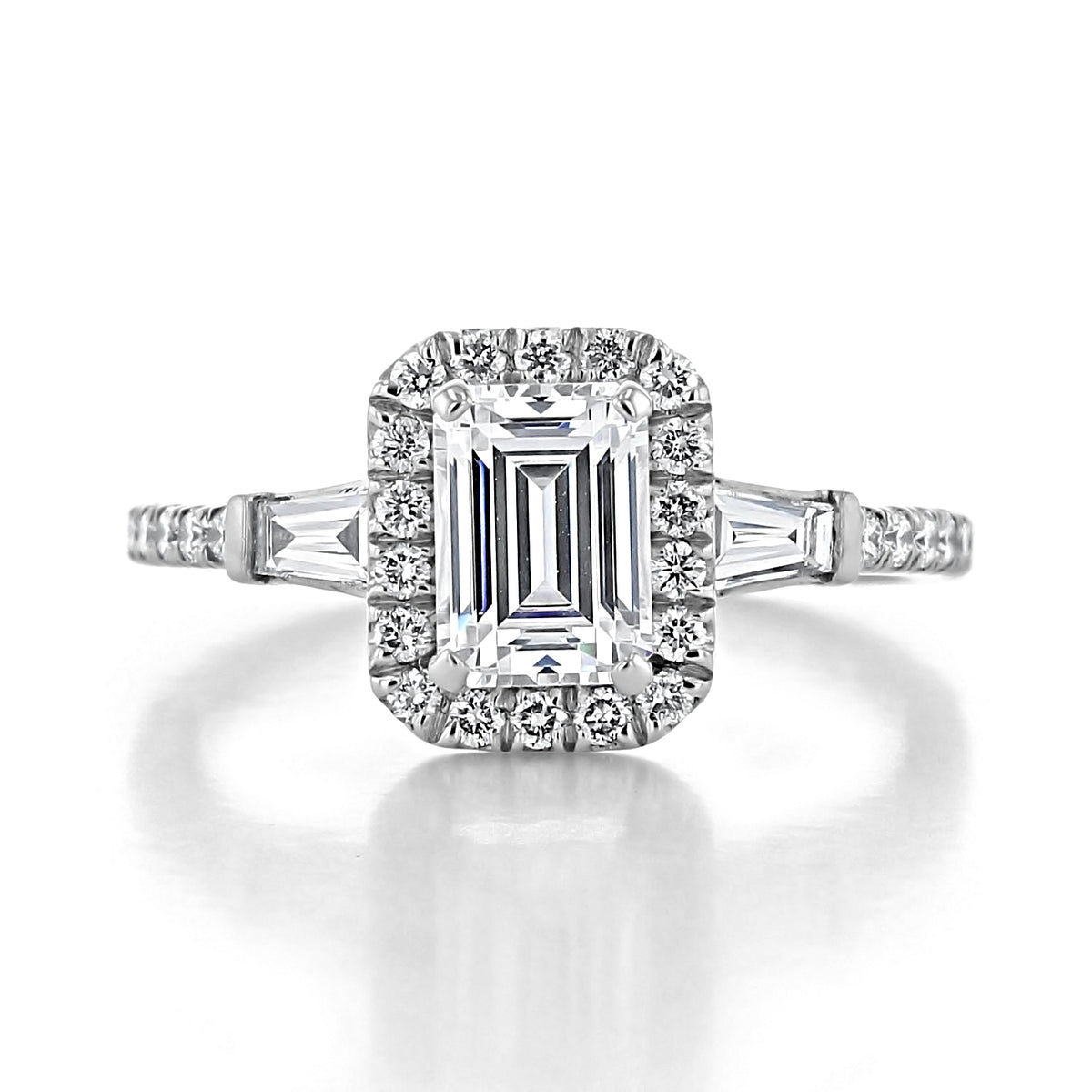 Larkin | Three-Stone Engagement Ring by Gabriel & Co. featuring a vintage-style emerald-cut diamond with a rectangular halo and tapered baguette diamonds on each side of the band.