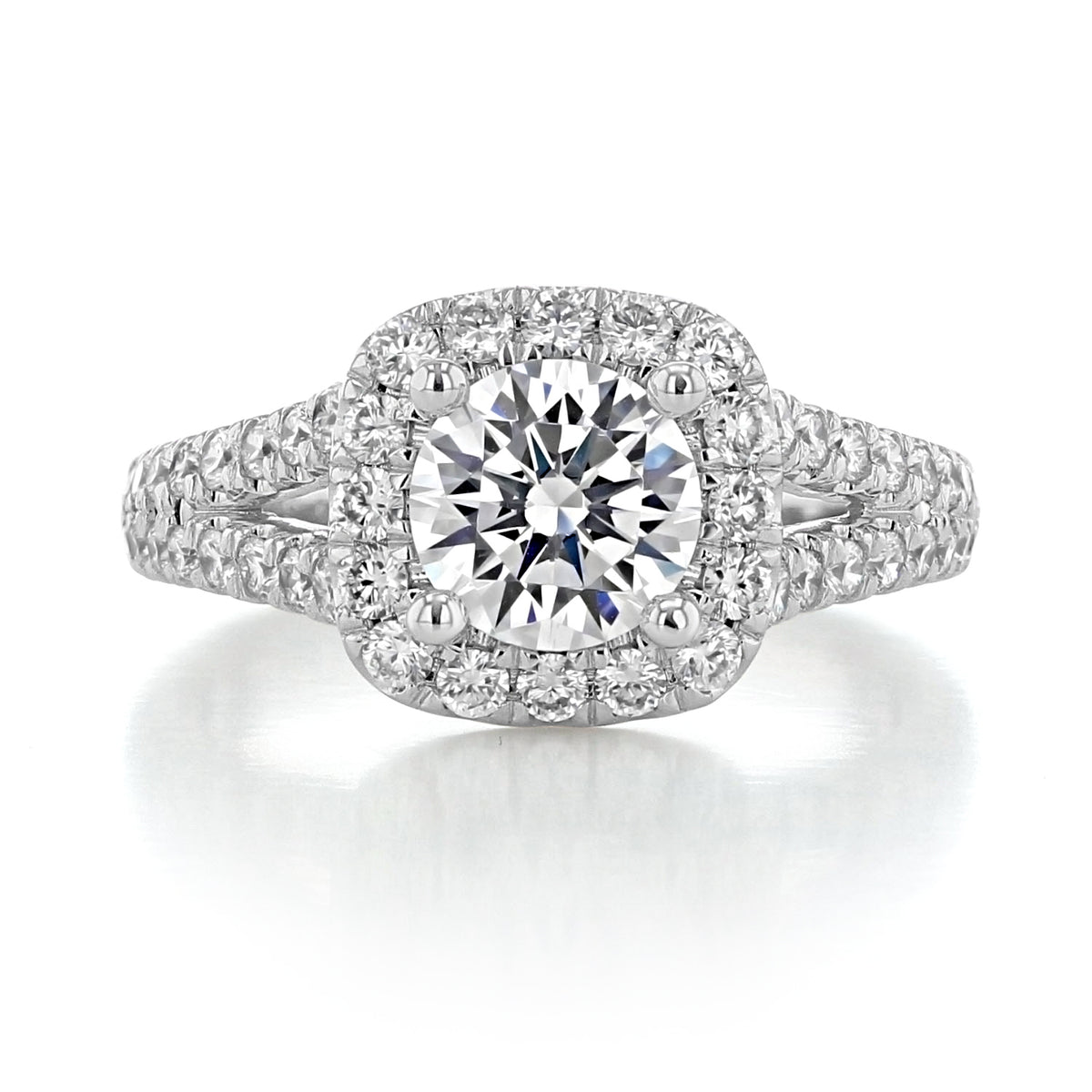 James | Halo Engagement Ring by Gabriel & Co. featuring a round center diamond, a cushion halo, and a split-shank band set with small pavé diamonds.