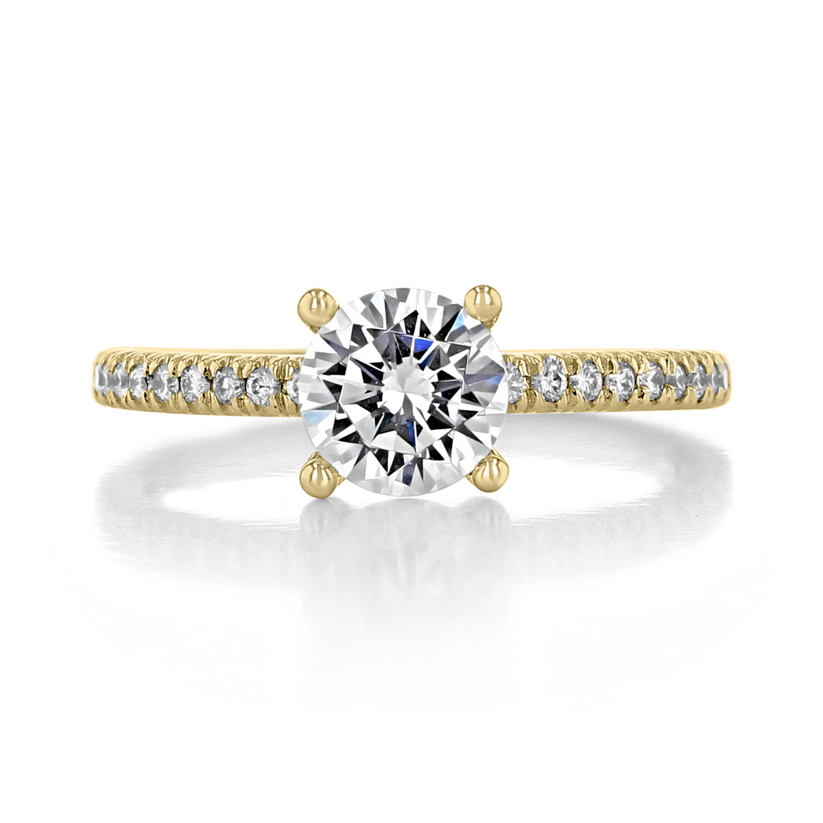 Gold ring with a large diamond and smaller diamonds on the band against a white background