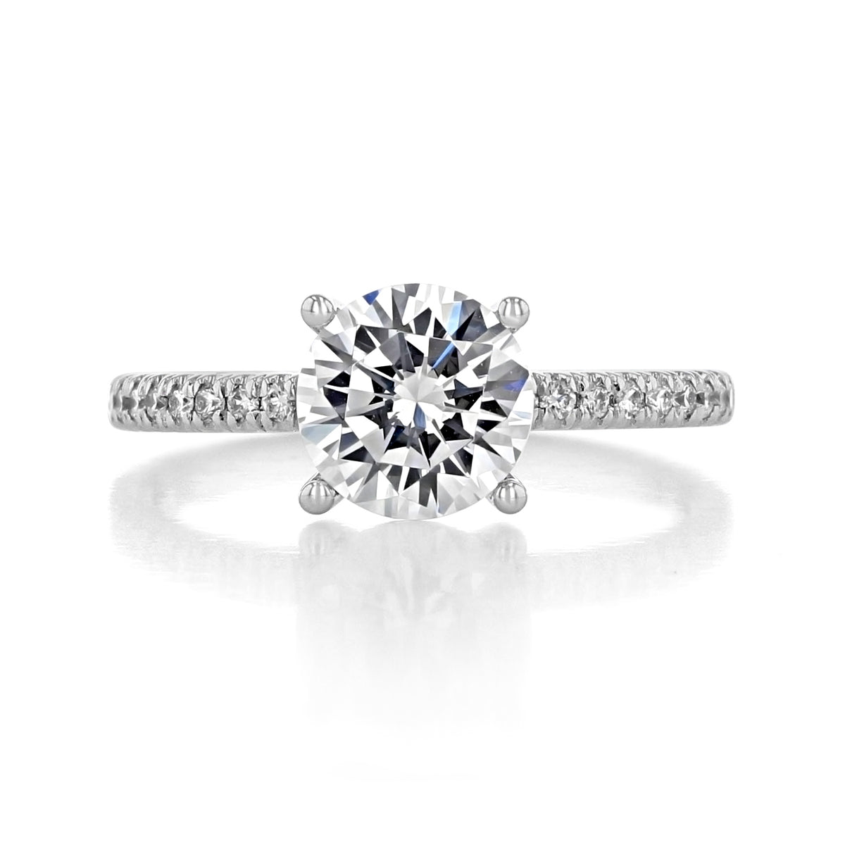Amira Micro-Prong Engagement Ring by Gabriel & Co. featuring a round-cut solitaire diamond on a pavé band.