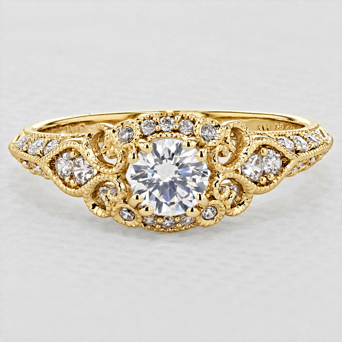 Abel | Halo Engagement Ring by Gabriel & Co. featuring a gold halo setting with a round center stone, intricate scrolling filigree, and smaller diamonds along the band.