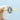 A yellow gold Royal T | Emerald Solitaire Engagement Ring - HT2625EC9X7Y featuring an emerald cut diamond held by four detailed prongs.