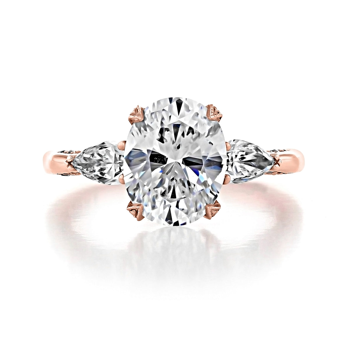 A Tacori RoyalT | Oval Solitaire Engagement Ring - HT2628OV10X8PK featuring an oval-cut center gemstone with two pear-shaped side stones set on a rose gold band.