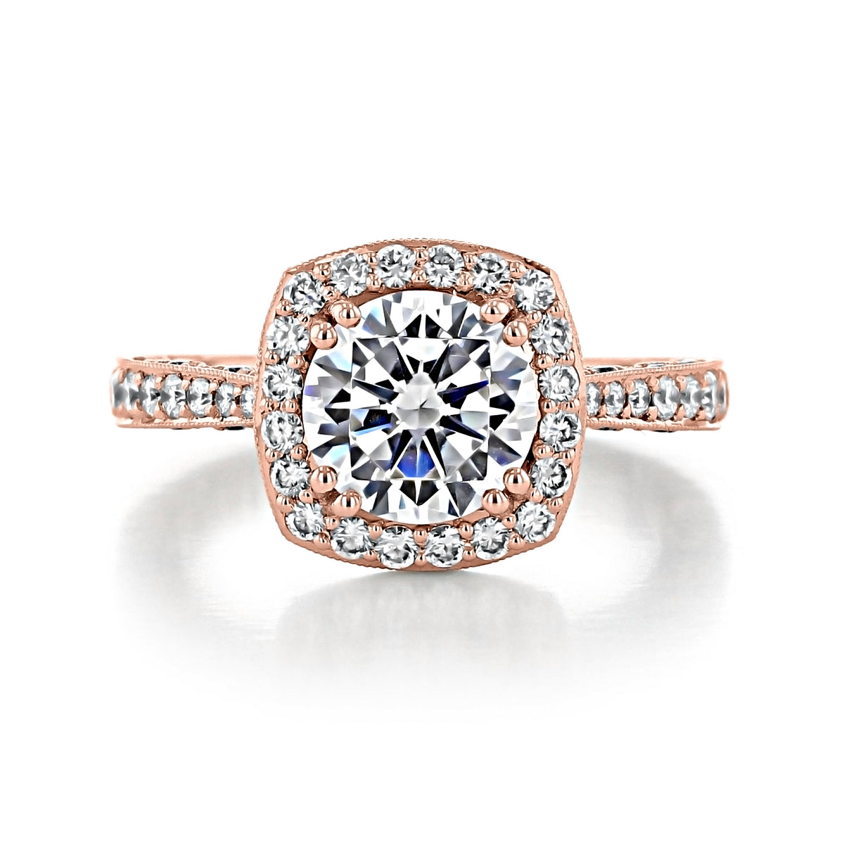 A round-cut diamond RoyalT | Cushion Pavé Engagement Ring - HT2650CU8PK in an 18k rose gold cushion-shaped halo setting with pavé-set diamonds on the band.