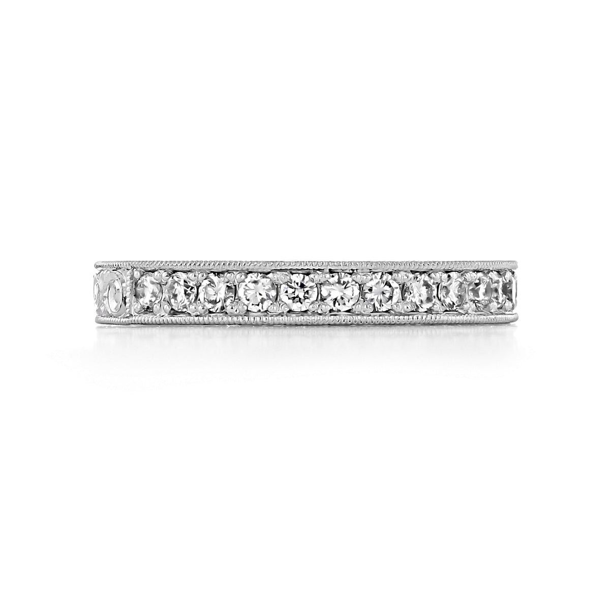 The Sabina 3mm Engraved Pavé-Set Diamond Wedding Band is a vintage white gold ring featuring a row of pavé-set round diamonds framed by milgrain edges.