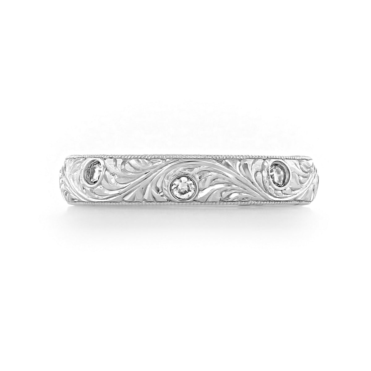 Engraved Diamond Band | LB39, a vintage-inspired platinum band featuring ornate scrolling leaf engravings and three flush-set round diamonds.