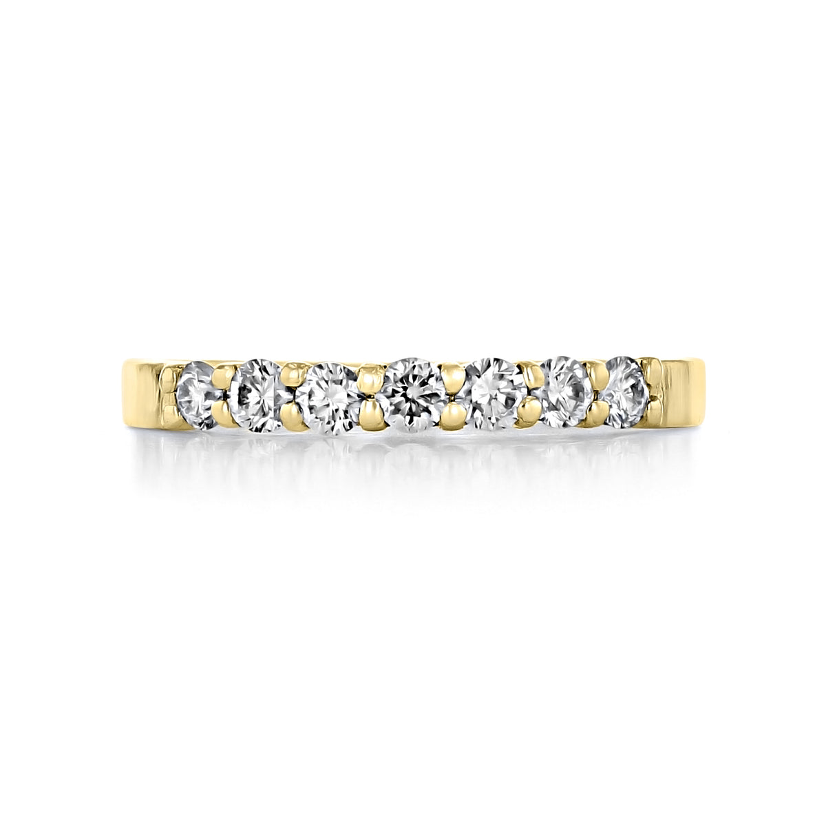 Marabel prong-set diamond wedding band in 14k yellow gold, featuring seven round-cut diamonds in prong settings.
