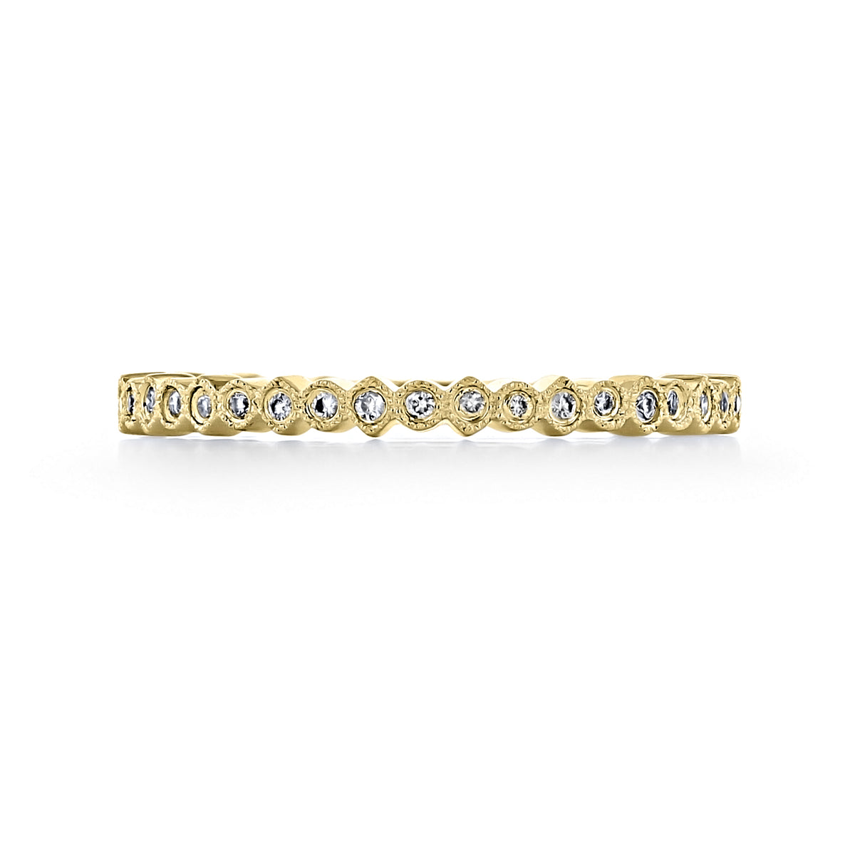 Terra | Round Bezel-Set Diamond Wedding Band by Icing On The Ring, featuring a gold band with a row of round, bezel-set diamonds and delicate milgrain details.