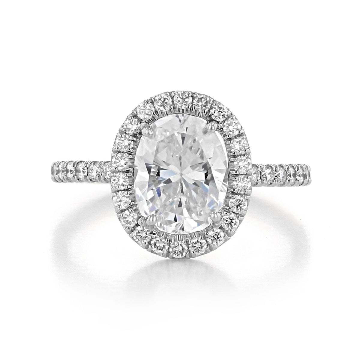 Danhov Per Lei | Engagement Ring - LE102-OV featuring an oval-cut diamond, a halo of accent stones, and a pavé band.