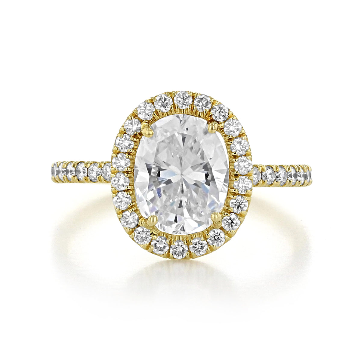 Danhov Per Lei | Engagement Ring - LE102-OV featuring an oval-cut center stone with a halo setting and pavé-set diamonds along a yellow gold band.