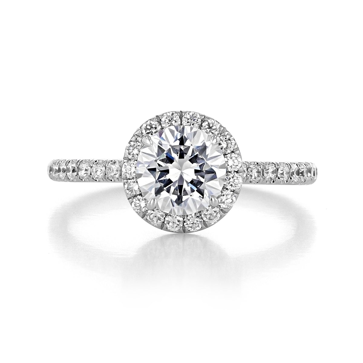 The Danhov Per Lei | Halo Engagement Ring - LE102 is a round-cut diamond ring featuring a halo of small diamonds and a pavé-set band.