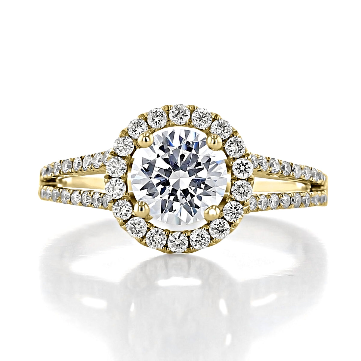 Habra | Round Halo Engagement Ring featuring a 1-carat center diamond on a split gold band accented with small pavé diamonds.