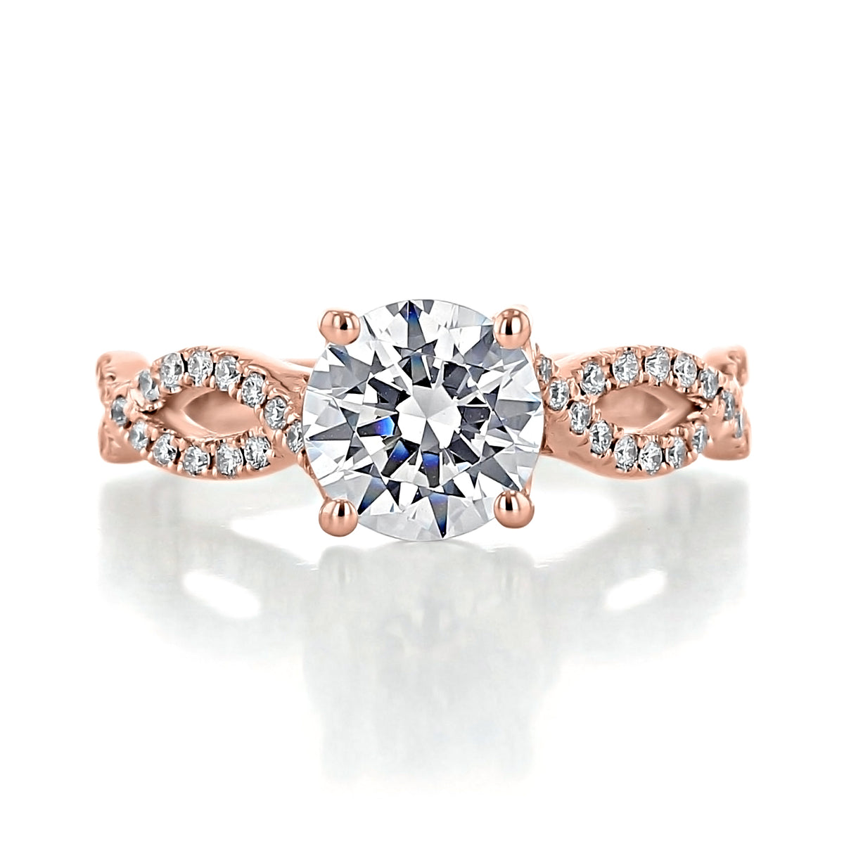 Calista | Round Diamond Twist Engagement Ring featuring a 1.25-carat round diamond solitaire on a rose gold twisted band accented with micro-prong-set pavé diamonds.