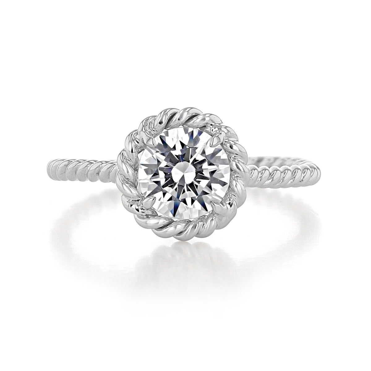 A Danhov Solo Filo | Braided Engagement Ring - SE106 featuring a round-cut diamond, a unique braided metal band, and a twisted halo setting.
