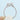 A round-cut diamond Solo Filo | Braided Engagement Ring - SE106 with a braided metalwork, rope-style band held by a person’s fingers.