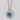 Gemma Bloom Bold London Blue Topaz Fashion Necklace SN14133 featuring a silver circular pendant with a round London blue topaz set in a decorative frame with a gold accent at the top.