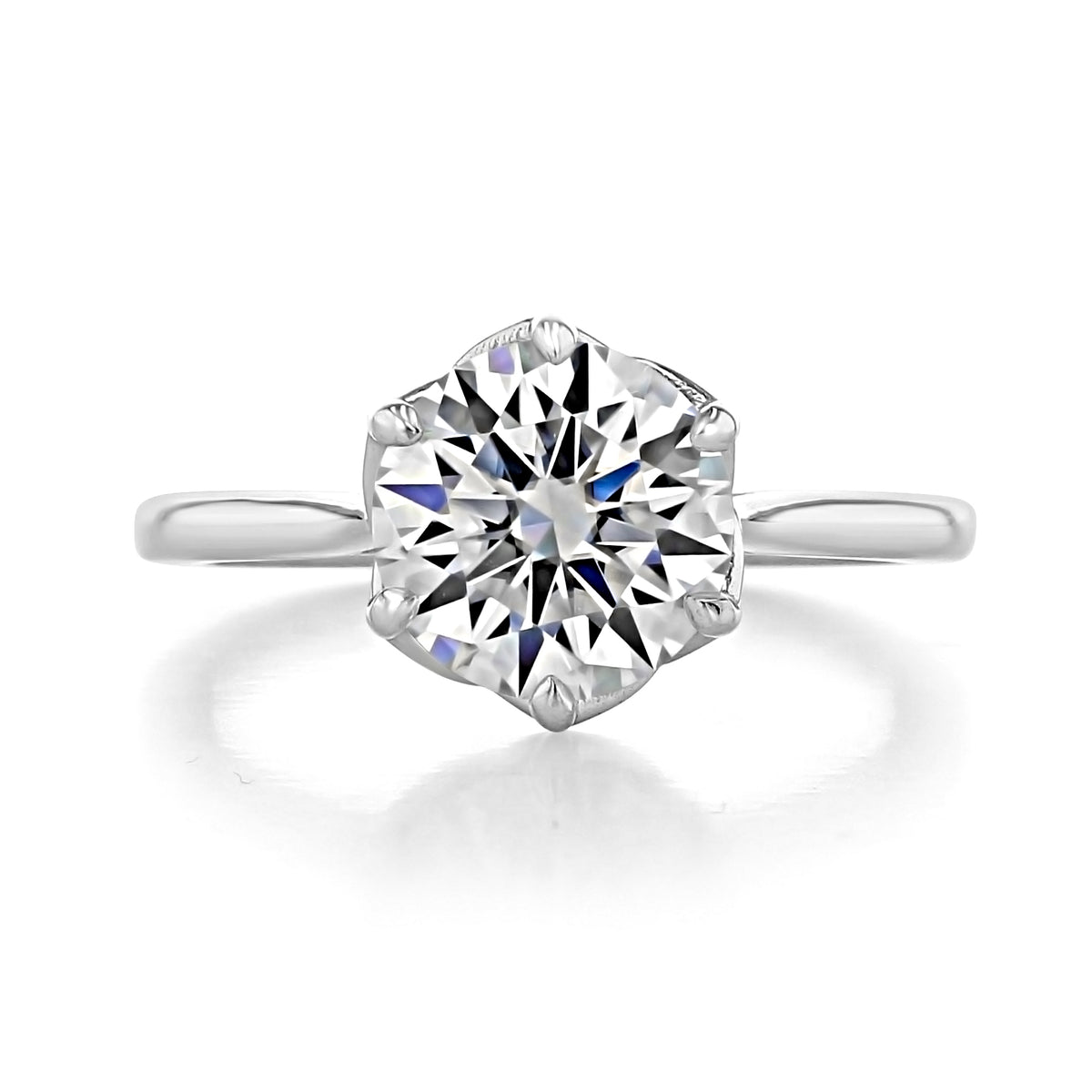 A silver Delilah | Round Solitaire Engagement Ring featuring a round diamond held by a tulip 6-prong crown.