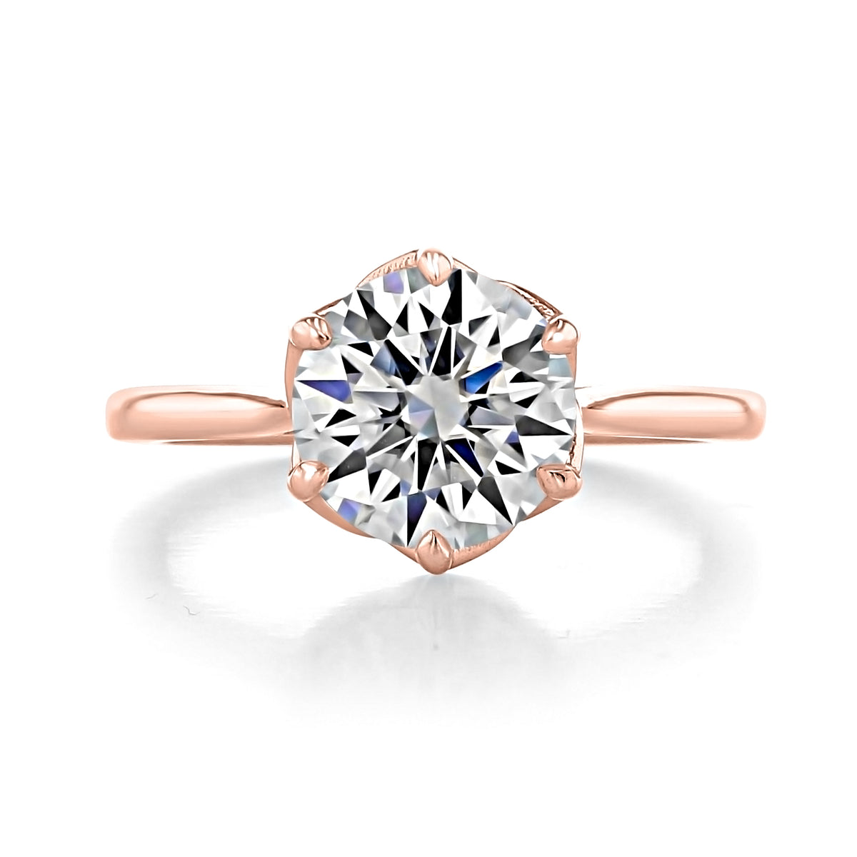 Delilah | Round Solitaire Engagement Ring featuring a round diamond set in a rose-gold cathedral band with a tulip six-prong crown.