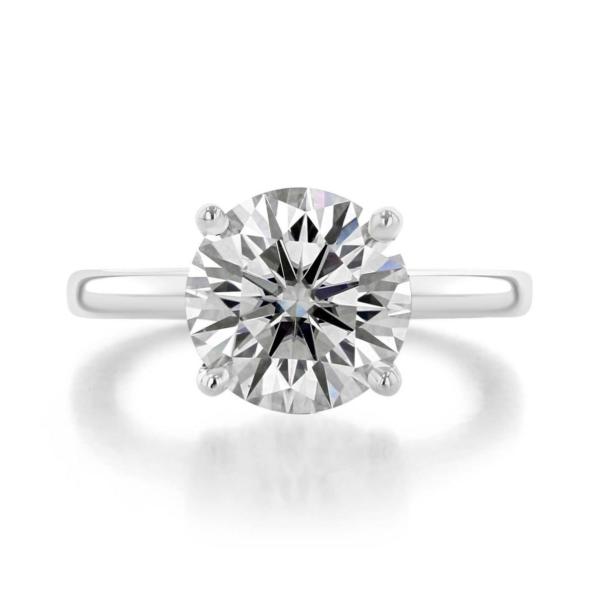 Icing On The Ring Olympic round solitaire engagement ring in platinum, featuring a round center diamond in a four-prong setting.