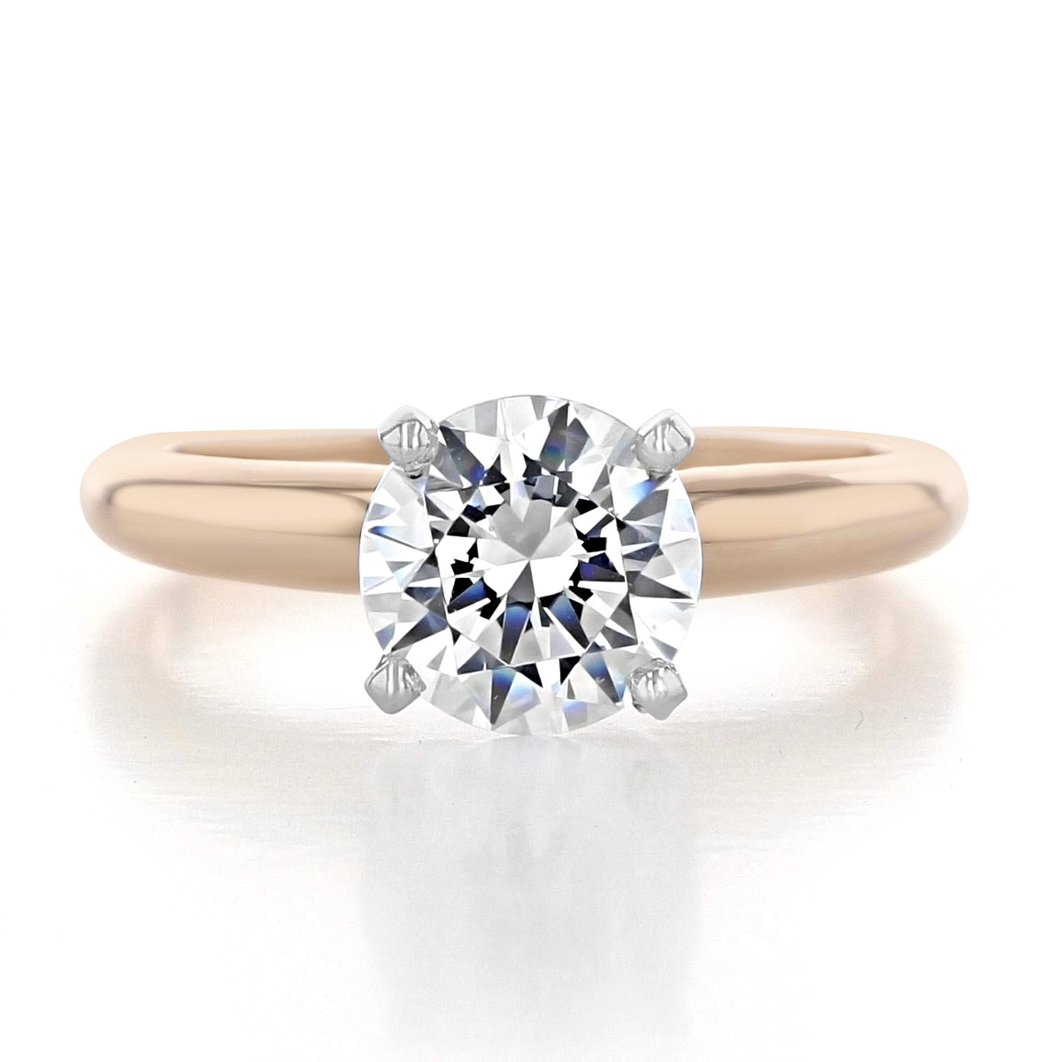 A round-cut diamond solitaire engagement ring, the Solitaire Proposal Ring | SO38, set on a smooth 14k rose gold band with four prongs.