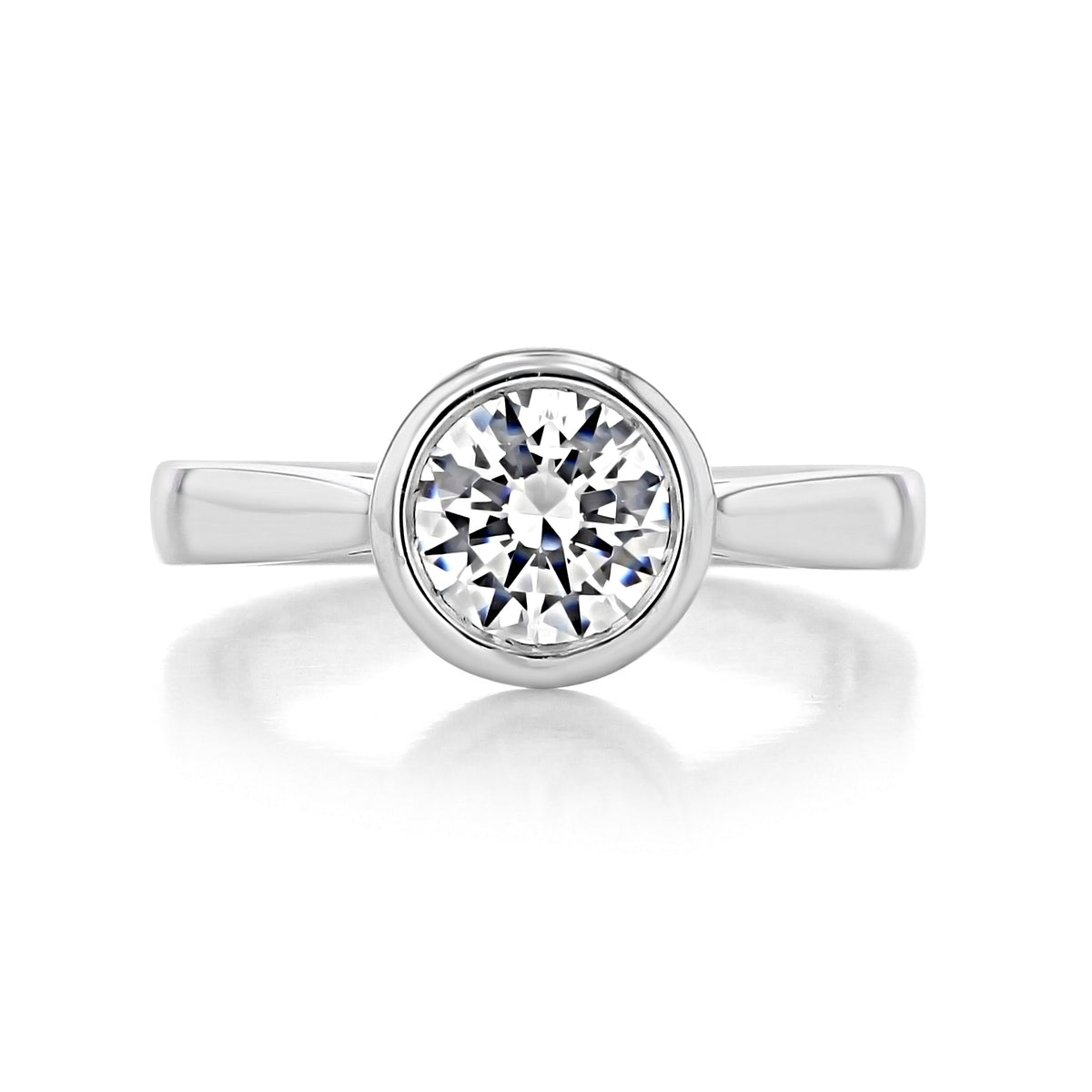Azure round bezel solitaire engagement ring in an Art-deco style with a round diamond in a silver-toned bezel setting on a smooth metal band.