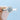 The Azure | Round Bezel Solitaire Engagement Ring features a round center diamond in an art-deco style bezel setting on a polished metal band held by fingers.