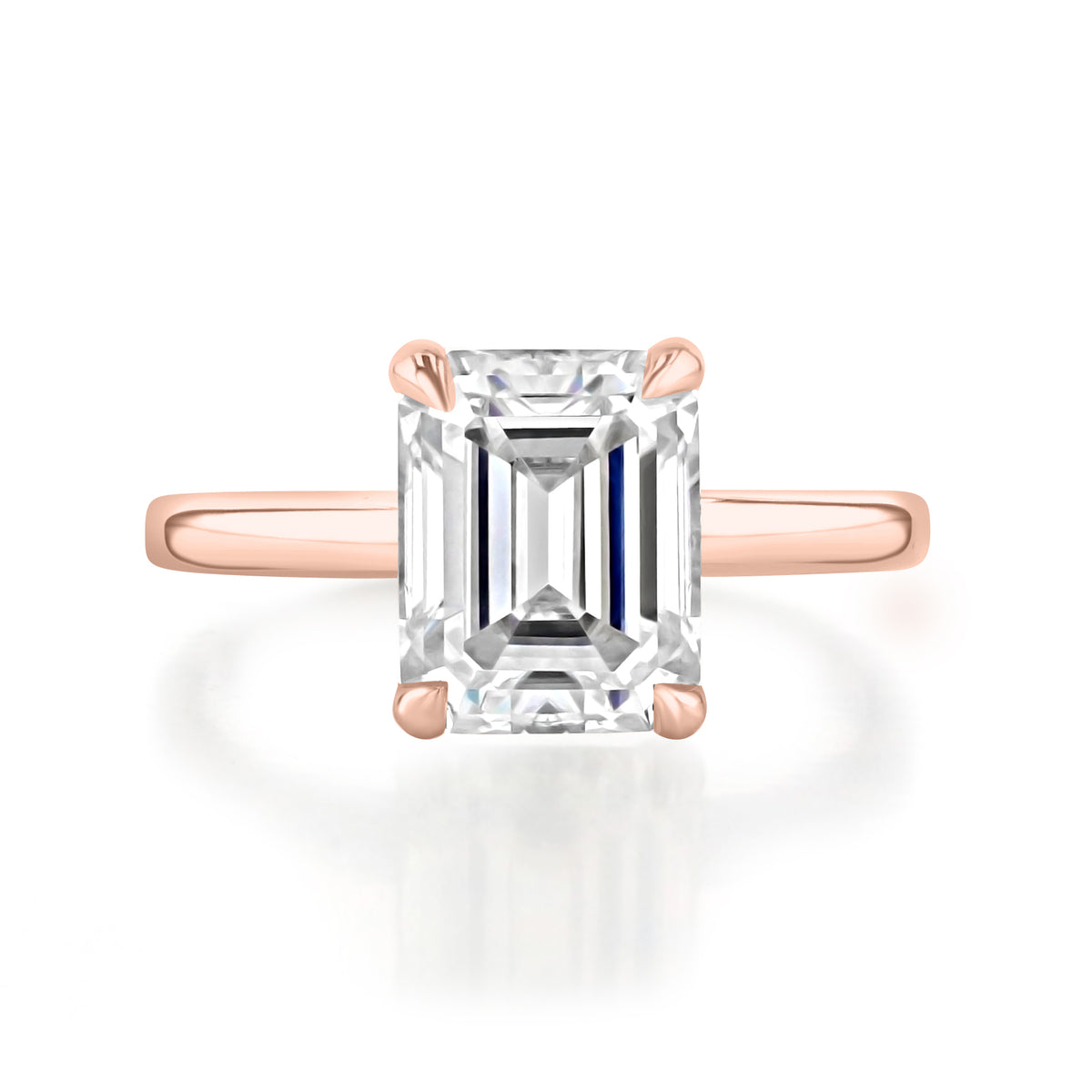 Laurel Emerald Solitaire Engagement Ring featuring an emerald-cut diamond set in a rose gold band with four prongs.