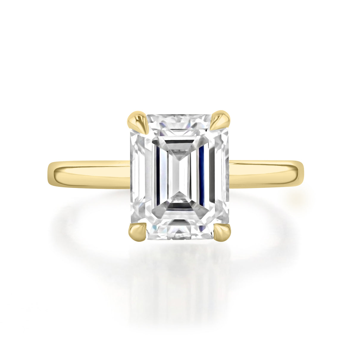 Laurel emerald-cut diamond solitaire engagement ring set in a classic yellow gold four-prong band.