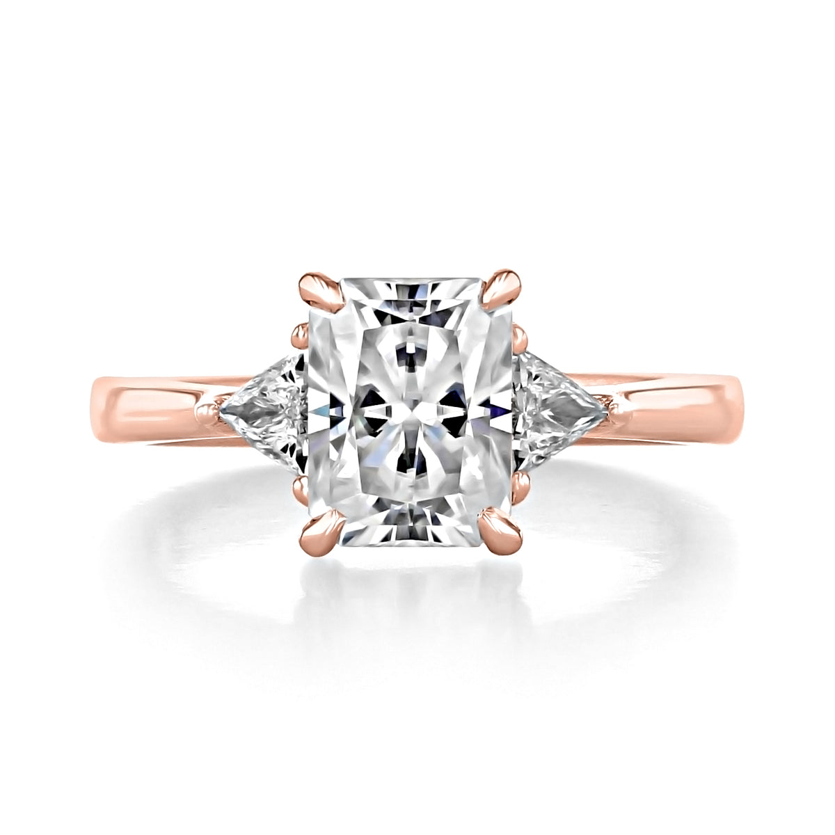 Emery | Trillion Three-Stone Engagement Ring in 14k rose gold, featuring a rectangular Radiant Cut Moissanite center stone flanked by two trillion-cut side stones.