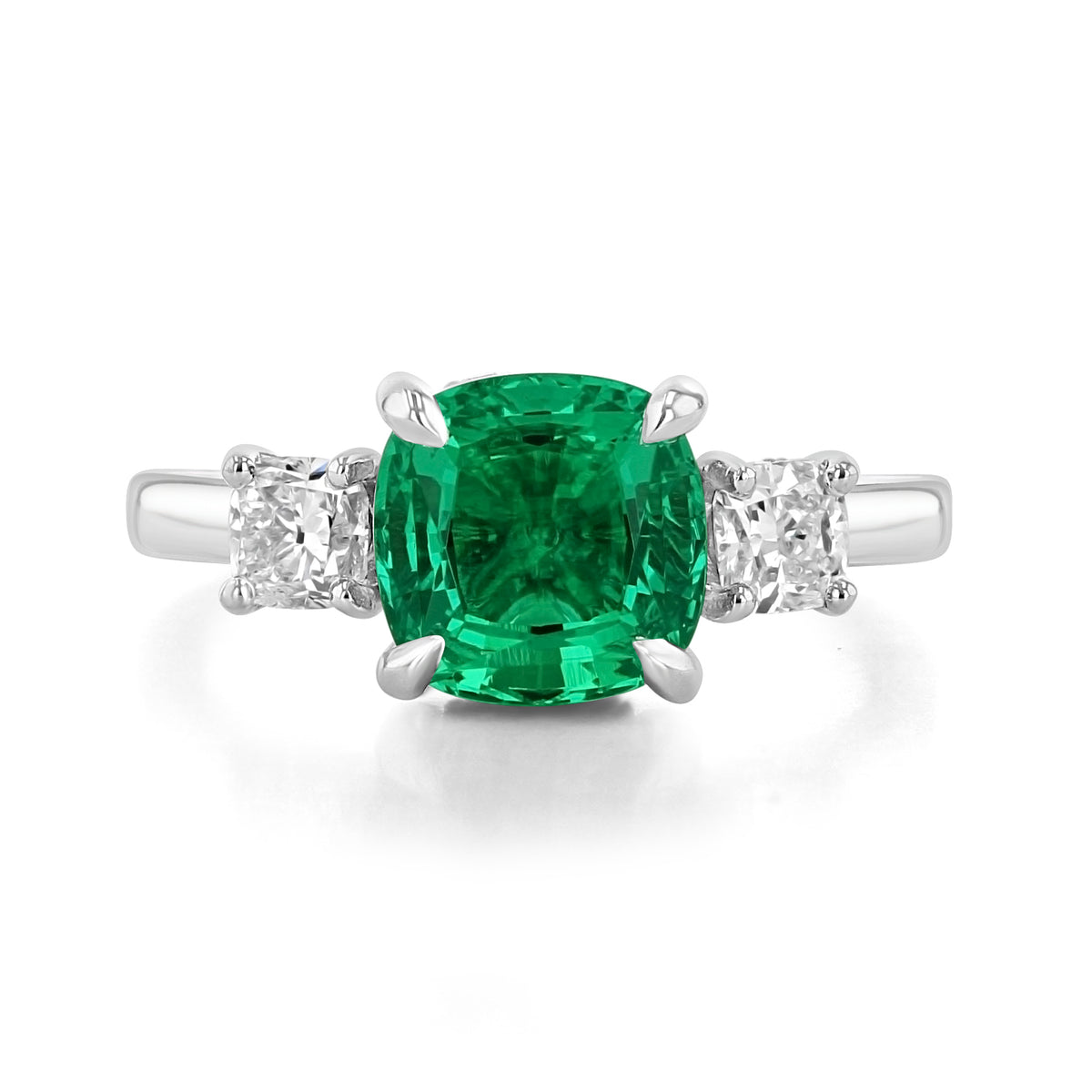 Emerald Three-Stone Engagement Ring | TR97 featuring a cushion-cut lab-created emerald flanked by two square-cut diamonds on a white gold band.