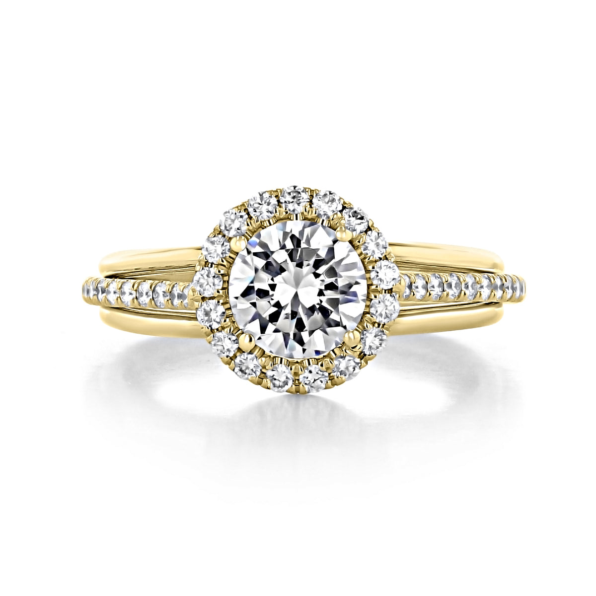 Danhov Unito | Halo Engagement Ring - UE112: a handcrafted 18k yellow gold ring with a round center stone, a halo of small diamonds, and a split-shank band accented with pavé diamonds.