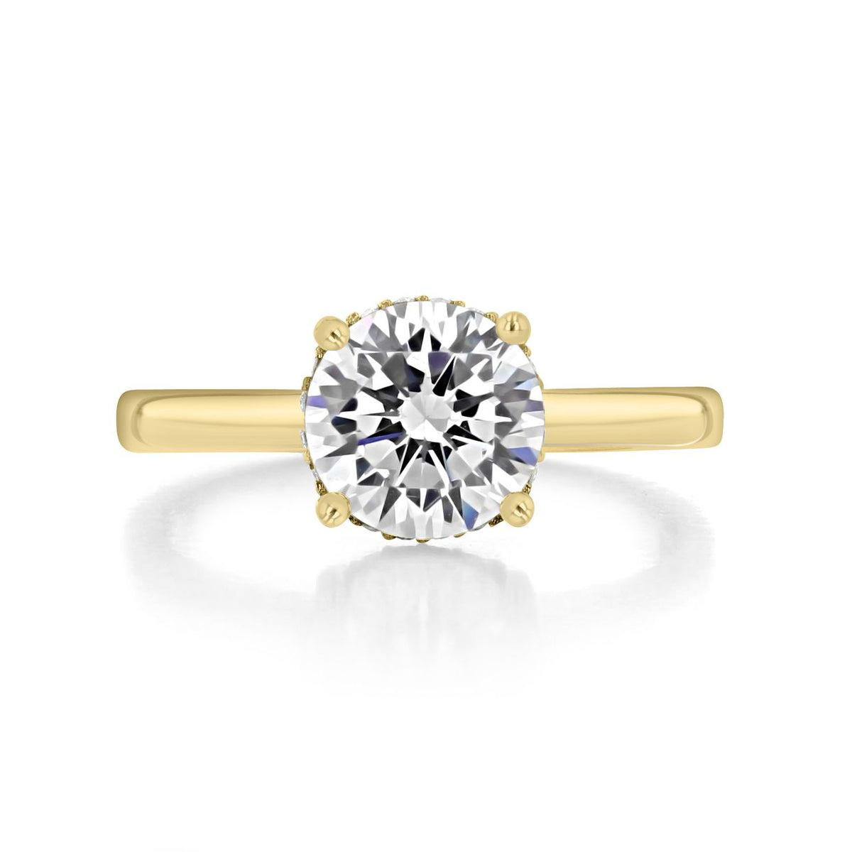 Kaia round solitaire engagement ring with a round brilliant-cut diamond on an 18K yellow gold band.